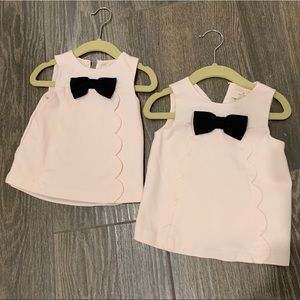 Two light pink Kate Spade tank tops with black bow. 18 months and 24 months.